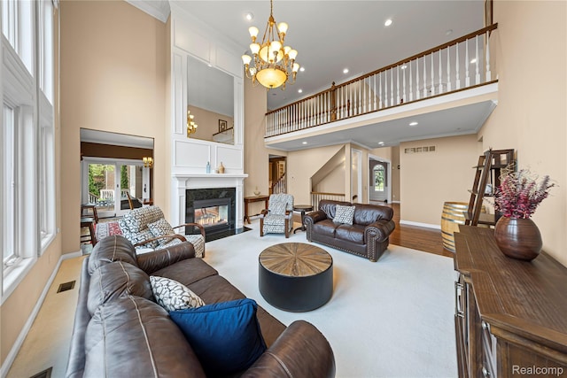 2401 Spyglass Dr, Oakland, MI 48363 - living area with a high ceiling, a chandelier, recessed lighting, a high end fireplace, and ornamental molding