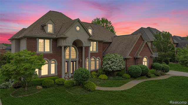 2401 Spyglass Dr, Oakland, MI 48363 - view of front of house with brick siding, roof with shingles, and a lawn