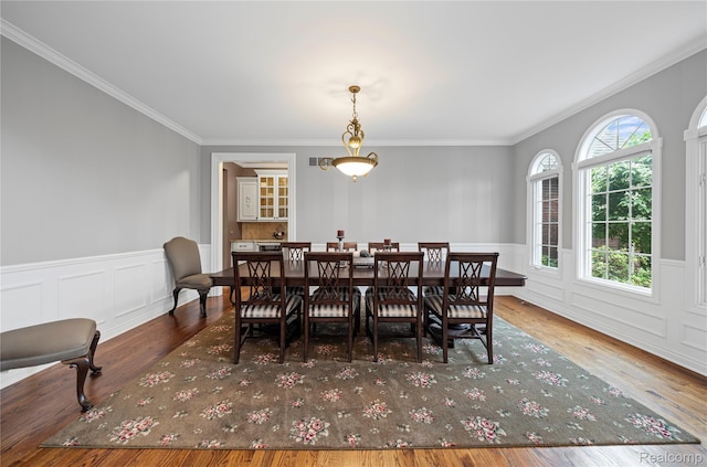 2401 Spyglass Dr, Oakland, MI 48363 - dining space with wood finished floors, crown molding, wainscoting, and a decorative wall