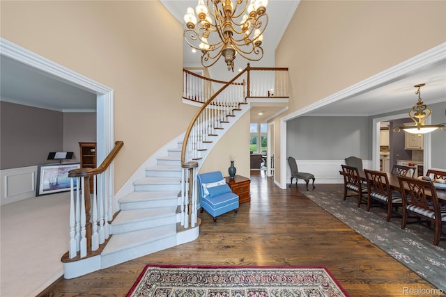 2401 Spyglass Dr, Oakland, MI 48363 - entrance foyer with stairway, a chandelier, wood finished floors, a wainscoted wall, and a high ceiling