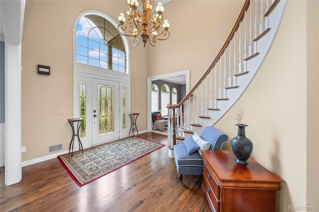 2401 Spyglass Dr, Oakland, MI 48363 - foyer entrance with wood finished floors, stairway, a chandelier, and a towering ceiling