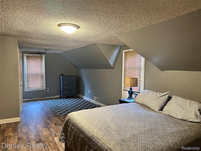 1286 Elmer Rd, Sandusky, MI 48471 - bedroom with wood finished floors, baseboards, a textured ceiling, and lofted ceiling