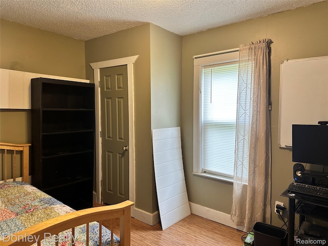 1286 Elmer Rd, Sandusky, MI 48471 - bedroom featuring light wood-type flooring, a textured ceiling, and baseboards