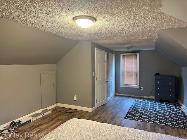 1286 Elmer Rd, Sandusky, MI 48471 - additional living space featuring wood finished floors, vaulted ceiling, baseboards, and a textured ceiling