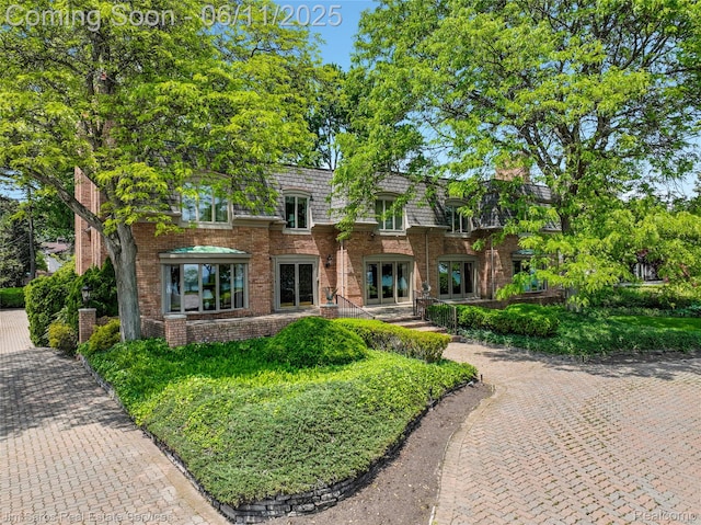 561 Lake Shore Rd, Grosse Pointe Shores, MI 48236 - view of front of house with french doors, brick siding, and mansard roof