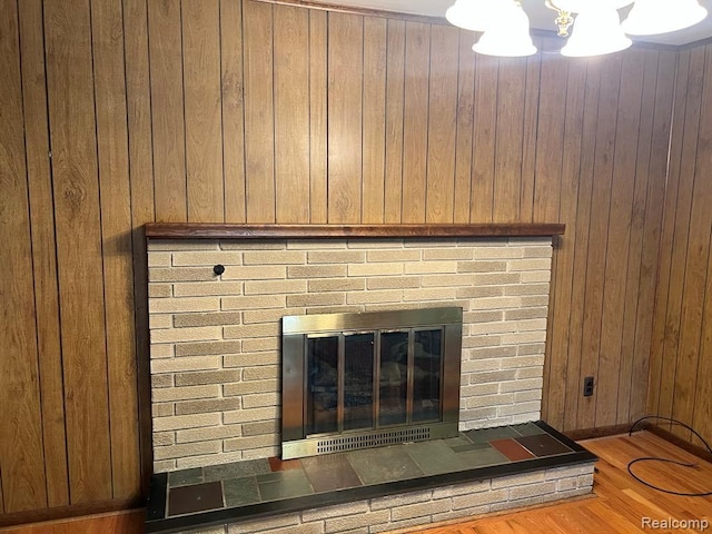 2763 Ranieri Dr, Troy, MI 48085 - detailed view of wooden walls, a fireplace, wood finished floors, and a chandelier