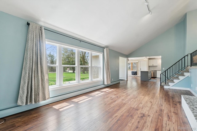 2064 N Long Lake Rd, Fenton, MI 48430 - unfurnished living room with stairs, dark wood-style flooring, track lighting, high vaulted ceiling, and baseboards