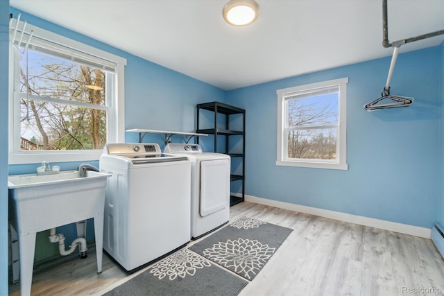 2064 N Long Lake Rd, Fenton, MI 48430 - washroom featuring washing machine and dryer, light wood-style floors, baseboards, and baseboard heating