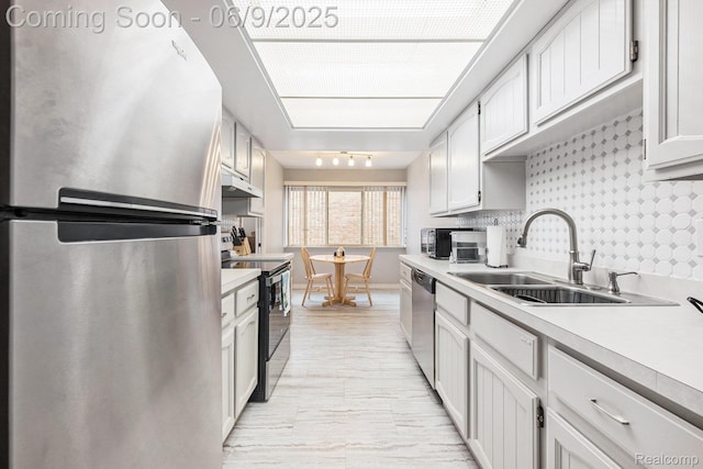 4483 Laurel Club Cir W, Bloomfield, MI 48323 - kitchen with appliances with stainless steel finishes, a sink, light countertops, under cabinet range hood, and baseboards