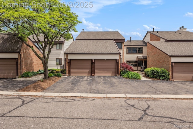 4483 Laurel Club Cir W, Bloomfield, MI 48323 - townhome / multi-family property featuring a shingled roof, brick siding, and a garage
