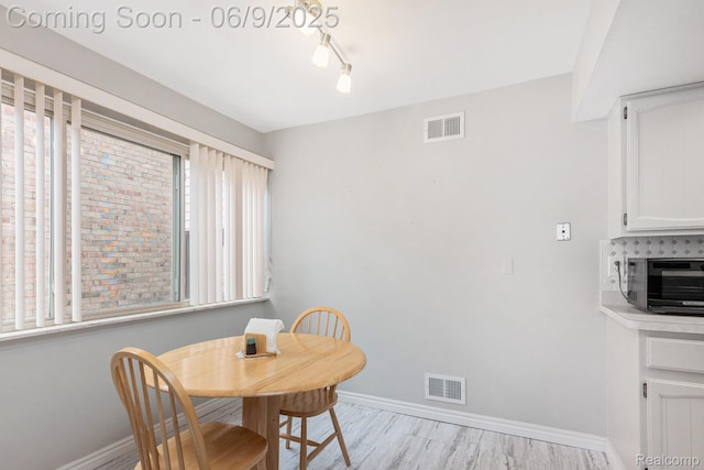 4483 Laurel Club Cir W, Bloomfield, MI 48323 - dining room with baseboards, track lighting, and light wood-style flooring