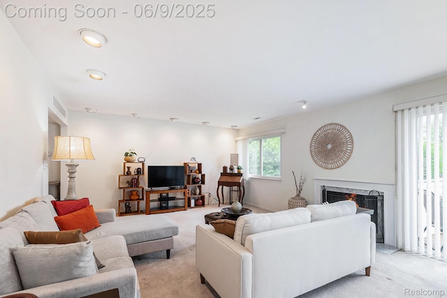 4483 Laurel Club Cir W, Bloomfield, MI 48323 - living area with light colored carpet and a warm lit fireplace