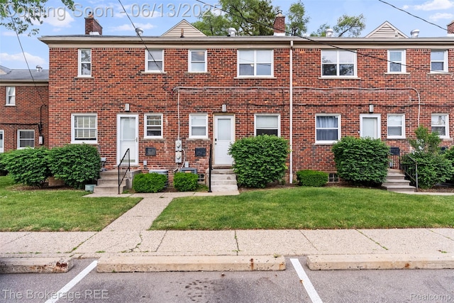 3344 Coolidge Hwy, Royal Oak, MI 48073 - townhome / multi-family property with entry steps, a chimney, brick siding, a front lawn, and uncovered parking