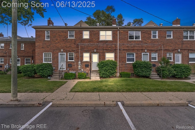 3344 Coolidge Hwy, Royal Oak, MI 48073 - view of property with a front lawn, uncovered parking, and brick siding