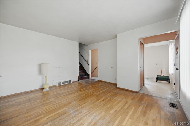 13332 Masonic Blvd, Warren, MI 48088 - unfurnished living room with stairs, hardwood / wood-style floors, and baseboards