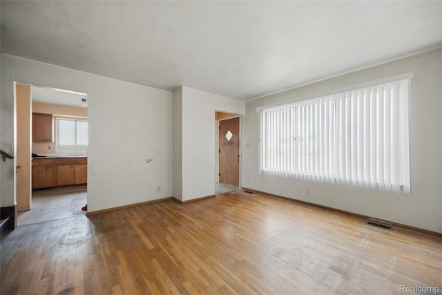 13332 Masonic Blvd, Warren, MI 48088 - unfurnished living room featuring baseboards, a sink, and hardwood / wood-style floors