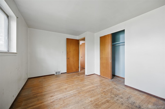 13332 Masonic Blvd, Warren, MI 48088 - unfurnished bedroom with wood finished floors, a closet, and baseboards