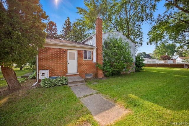 13332 Masonic Blvd, Warren, MI 48088 - view of front of property with a chimney, brick siding, and a front yard