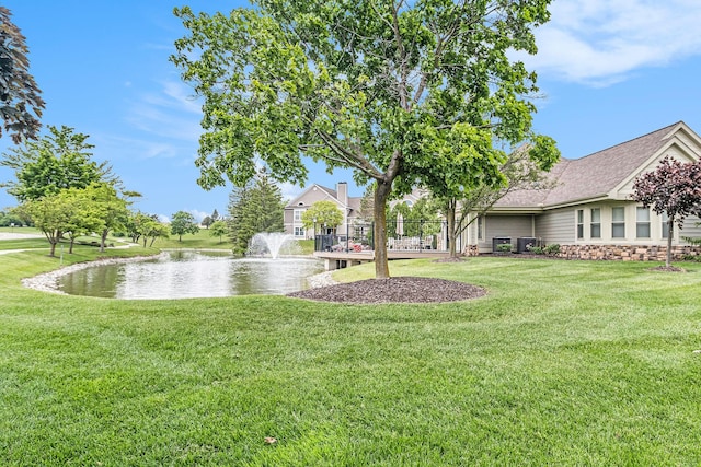 1599 Weatherstone Dr Unit 245, Ann Arbor, MI 48108 - view of grassy yard featuring a water view and central air condition unit