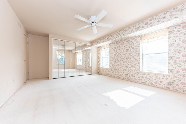 2705 Winthrop Ct, Ann Arbor, MI 48104 - spare room featuring carpet, wallpapered walls, and a ceiling fan