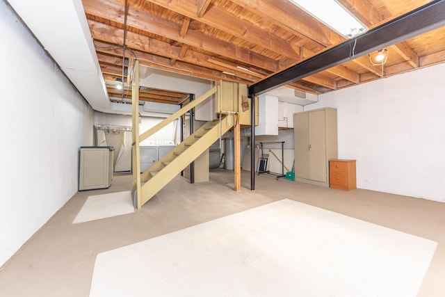 2705 Winthrop Ct, Ann Arbor, MI 48104 - unfinished below grade area featuring washing machine and dryer, stairs, and water heater