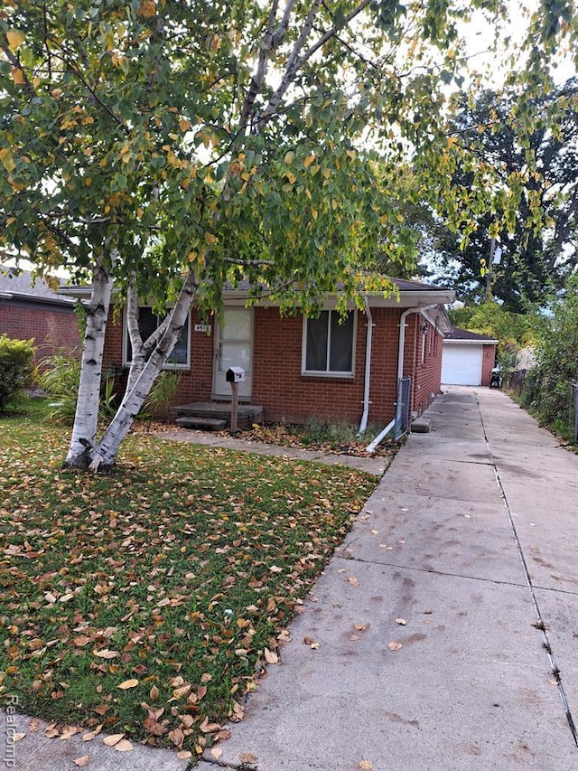 4510 Croissant St, Allen Park, MI 48125 - view of front of property featuring brick siding, a front lawn, and an outbuilding