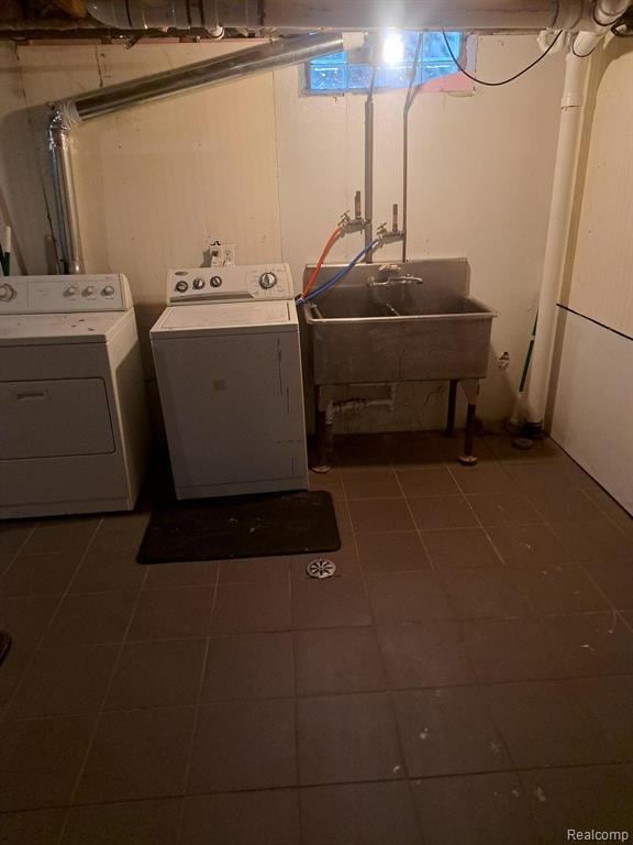 4510 Croissant St, Allen Park, MI 48125 - washroom with separate washer and dryer and dark tile patterned flooring