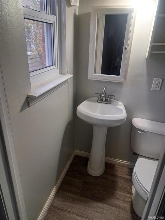 4510 Croissant St, Allen Park, MI 48125 - half bathroom with toilet, wood finished floors, and baseboards