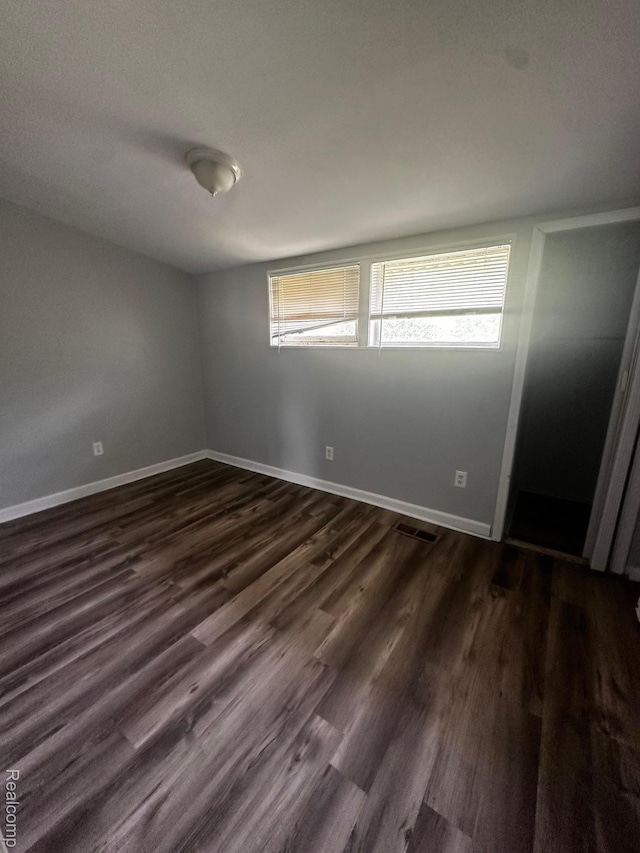811 Robinwood St, Pontiac, MI 48340 - spare room with plenty of natural light, baseboards, and dark wood finished floors