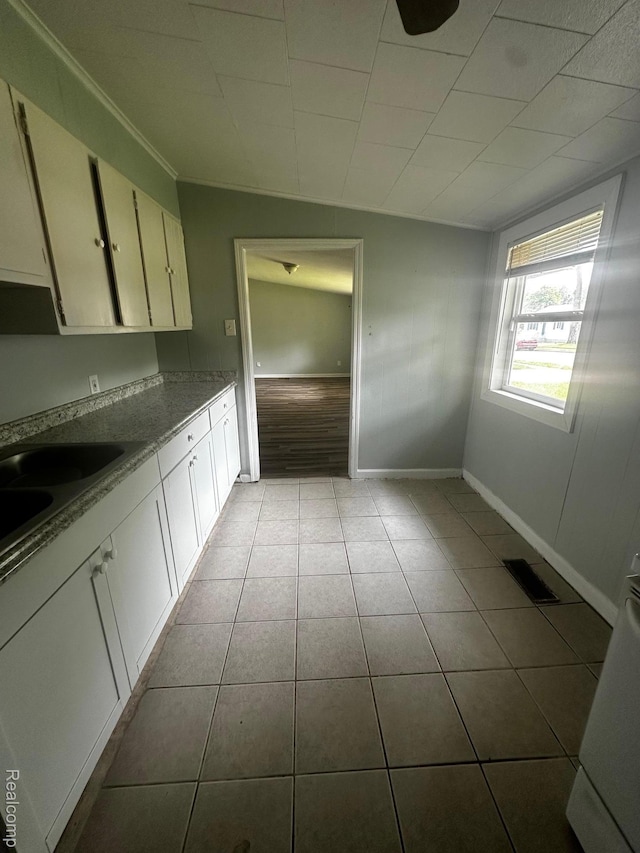 811 Robinwood St, Pontiac, MI 48340 - kitchen with tile patterned floors, baseboards, white cabinetry, and crown molding