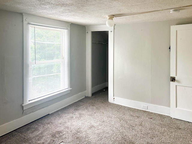 611 E Mount Hope Ave, Lansing, MI 48910 - unfurnished bedroom with a textured ceiling, carpet floors, baseboards, and a closet