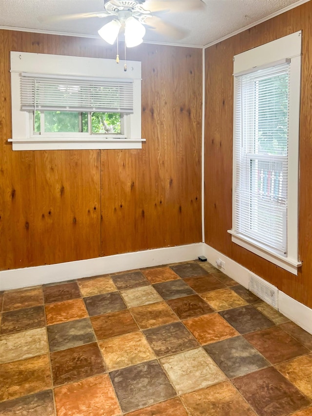 611 E Mount Hope Ave, Lansing, MI 48910 - unfurnished room featuring a ceiling fan and wooden walls