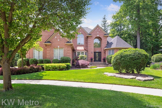 14163 Longneedle Ct, Shelby Twp, MI 48315 - traditional-style house featuring brick siding and a front yard