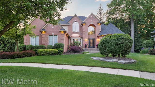 14163 Longneedle Ct, Shelby Twp, MI 48315 - traditional-style home with brick siding, a front yard, and a shingled roof