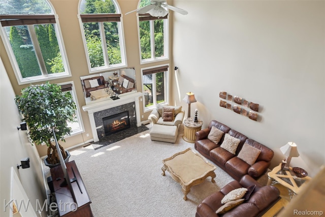14163 Longneedle Ct, Shelby Twp, MI 48315 - living room featuring carpet floors, a fireplace, a ceiling fan, plenty of natural light, and a towering ceiling