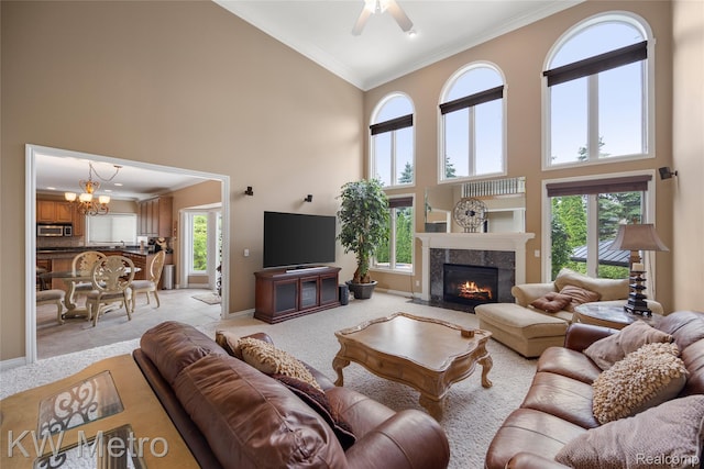 14163 Longneedle Ct, Shelby Twp, MI 48315 - living area with a towering ceiling, ornamental molding, a chandelier, plenty of natural light, and ceiling fan