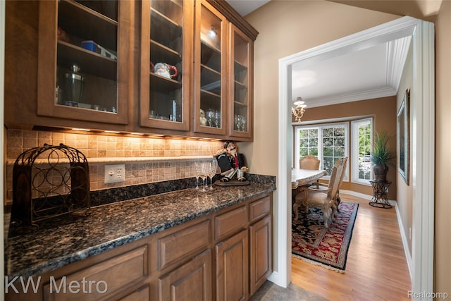 14163 Longneedle Ct, Shelby Twp, MI 48315 - bar featuring ornamental molding, light wood-style floors, and backsplash