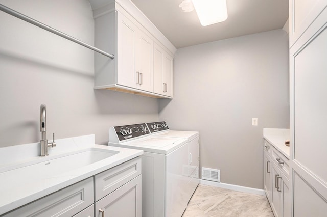 565 Hawksnest Dr, South Haven, MI 49090 - laundry area featuring washing machine and clothes dryer, cabinet space, and baseboards
