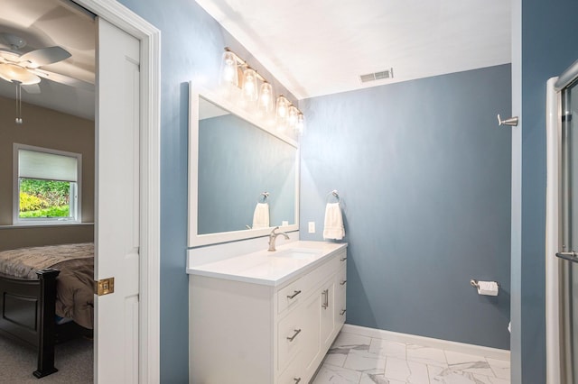 565 Hawksnest Dr, South Haven, MI 49090 - ensuite bathroom with a ceiling fan, vanity, marble look tiles, and baseboards