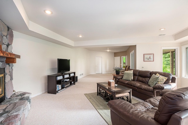 565 Hawksnest Dr, South Haven, MI 49090 - living room featuring carpet flooring, a stone fireplace, a raised ceiling, and recessed lighting