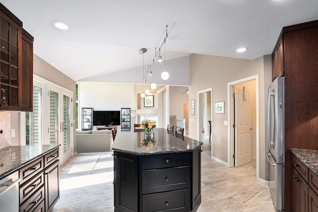 565 Hawksnest Dr, South Haven, MI 49090 - kitchen featuring vaulted ceiling, stainless steel appliances, dark stone countertops, hanging light fixtures, and a kitchen island