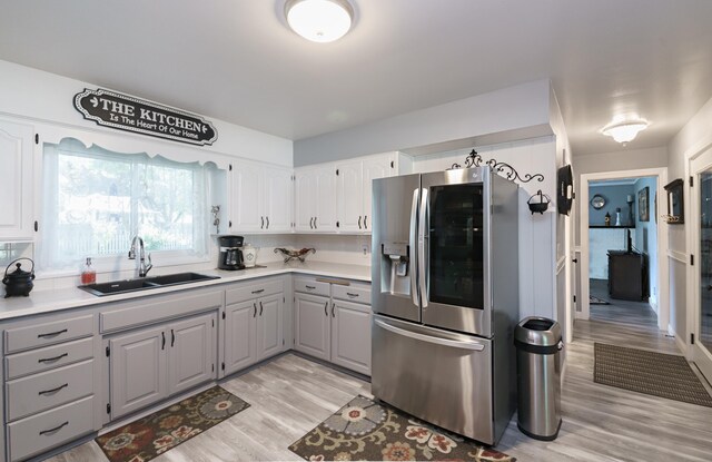 4143 Browning Dr, Saint Joseph, MI 49085 - kitchen featuring stainless steel fridge, a sink, gray cabinets, and light wood finished floors