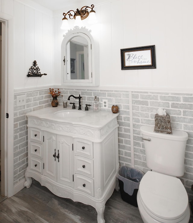 4143 Browning Dr, Saint Joseph, MI 49085 - bathroom with vanity, wood finished floors, and toilet