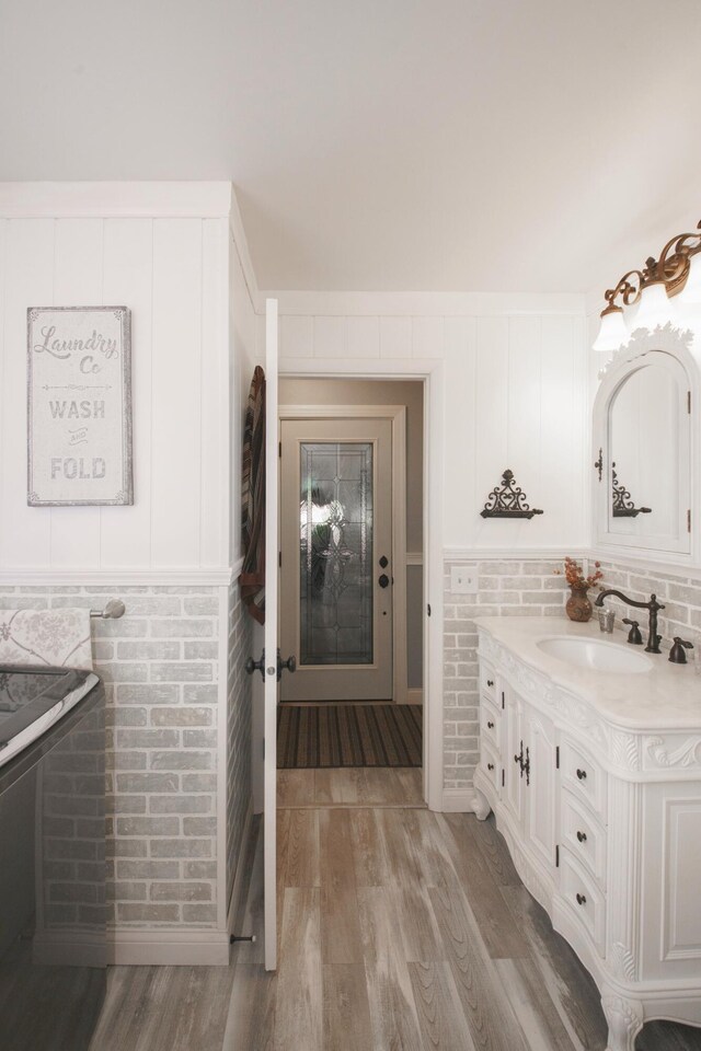 4143 Browning Dr, Saint Joseph, MI 49085 - bathroom featuring vanity, wood finished floors, and wainscoting