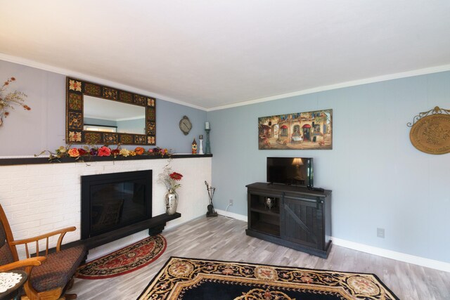 4143 Browning Dr, Saint Joseph, MI 49085 - living room featuring wood finished floors, a brick fireplace, crown molding, and baseboards