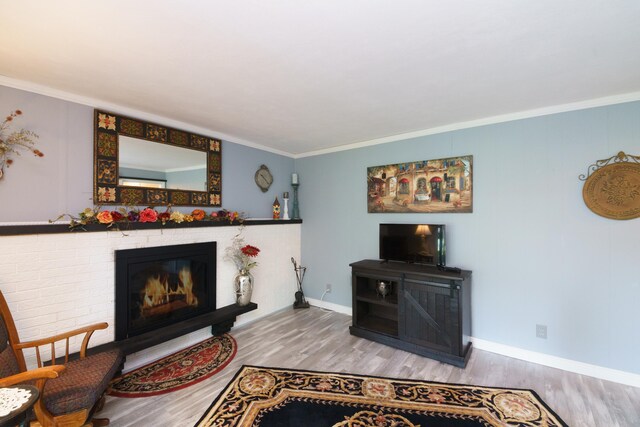 4143 Browning Dr, Saint Joseph, MI 49085 - living area with a brick fireplace, wood finished floors, ornamental molding, and baseboards