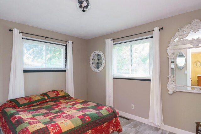 4143 Browning Dr, Saint Joseph, MI 49085 - bedroom featuring multiple windows, light wood-style flooring, and baseboards