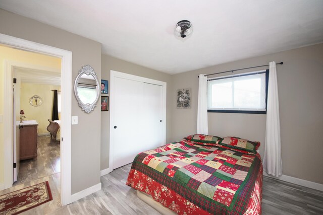 4143 Browning Dr, Saint Joseph, MI 49085 - bedroom featuring wood finished floors, a closet, and baseboards