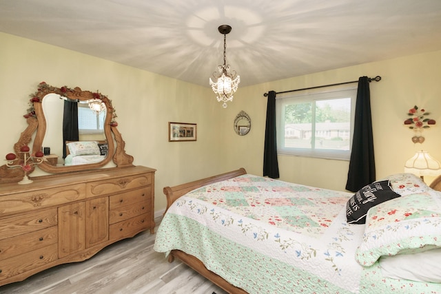 4143 Browning Dr, Saint Joseph, MI 49085 - bedroom with light wood finished floors and a chandelier