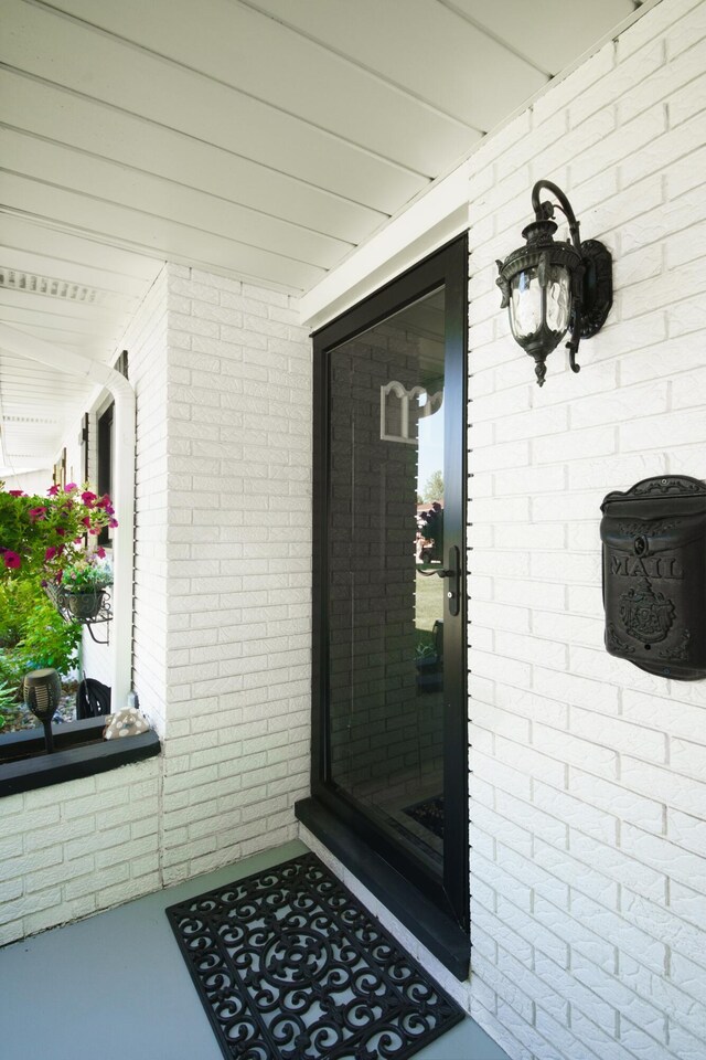 4143 Browning Dr, Saint Joseph, MI 49085 - property entrance featuring brick siding